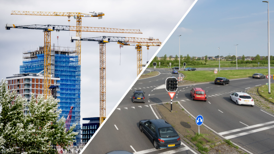 Flatgebouwen met bouwkranen en een rotonde met auto's